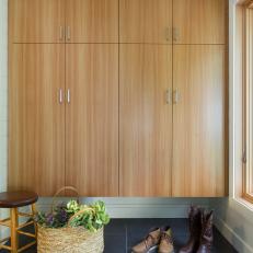Modern Mudroom With Built In Larch Wood Cabinet And Charcoal Gray Tile Floor