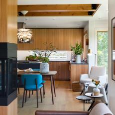 Open Concept Dining Room And Kitchen With Midcentury Modern Furnishings And Reading Nook