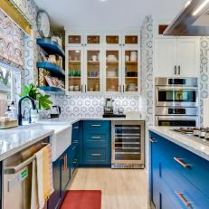 Modern Blue And White Kitchen With Marble Walls And Countertops And Stainless Steel Appliances