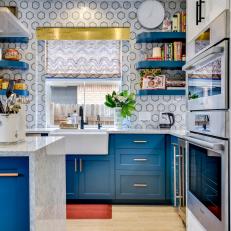 Modern Blue And White Kitchen With Bold Marble Wall Tile And Countertops And Metal Accents