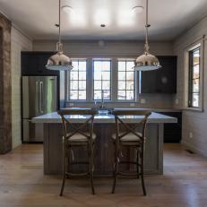 Neutral Kitchen With Thick Slab Countertops and Dark Wood Cabinets