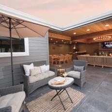 Contemporary Outdoor Living Room With Covered Patio And Wicker Seating