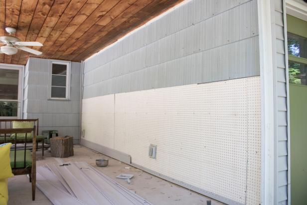 Removing insulation beneath siding.