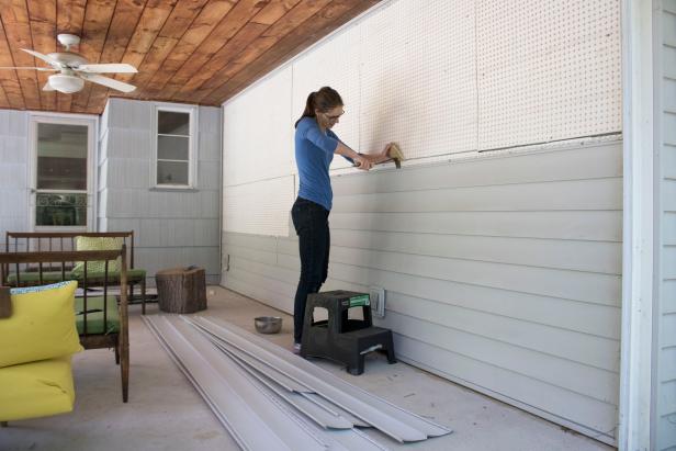 Removing insulation beneath siding.