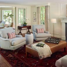 Traditional Living Room With Upholstered Chairs And Ottoman And Fireplace
