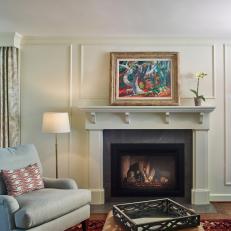 Traditional Living Room Detail With White Fireplace And Cozy Side Chair