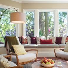 Traditional Sunroom With Built In Window Seat And Midcentury Modern Furnishings