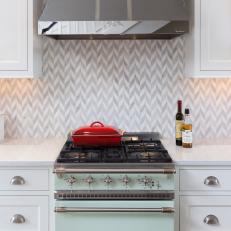 Traditional White And Gray Kitchen Detail With Tile Backsplash And Vintage Inspired Range
