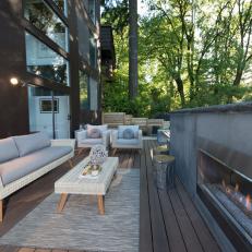 Contemporary Deck With Neutral Wicker Furnishings And Concrete Gas Fireplace