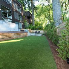 Contemporary Wooded Backyard With Concrete Wall And Modern Wood Fence