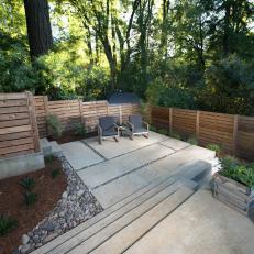 Backyard Sitting Area With Contemporary Landscaping And Modern Fence