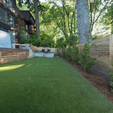 Contemporary Backyard Landscaped With Concrete And Modern Fence Details