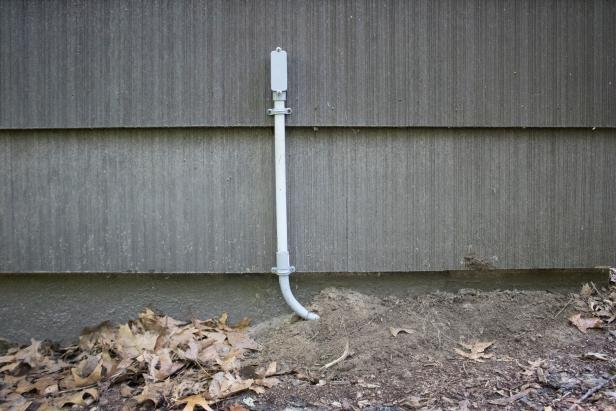 PVC conduit to protect wire where it emerges from the ground.