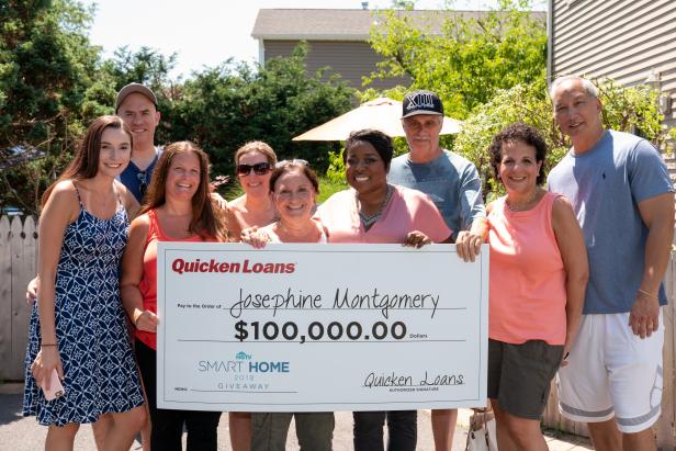 The Montgomery family poses with HGTV Host Tiffany Brooks as she surprises Josephine Montgomery of Farmingdale, New York, that she is the grand-prize winner of the HGTV Smart Home 2018 located in Buffton, SC, along with other prizes including a Mercedes and a check from Quicken Loans.