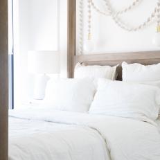 Draped Pendant Light, Soft White Linens Create Restful Space