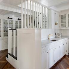 Built in Kitchen Wet Bar with Gray Marble Countertop, Glass Door Cabinets and Herringbone Wood Floor