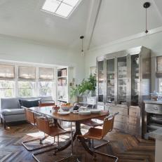 Vaulted Ceiling Dining Room With Mid-Century Modern Dining Set Up and Stainless Steel China Cabinet