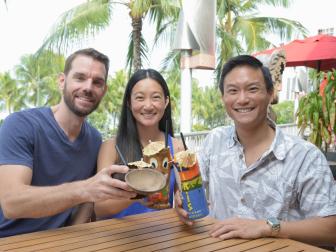 Oahu estate broker Wayne Chi (right) and clients Jenny Sou and Phil Ziegler discuss their home buying needs buy over tiki drinks, as seen on HGTV's My Aloha Dream Home.
