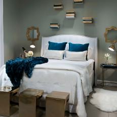 Eclectic Guest Bedroom With Floating Book Shelves And White And Gold Accents