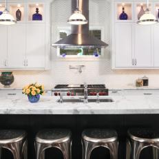 Contemporary Black And White Kitchen With Stainless Steel Accents And Blue Glass Art