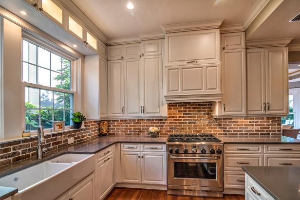 Contemporary Kitchen With White Cabinets And Brick Backsplash And Gray