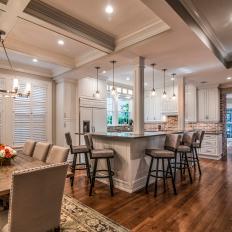 Contemporary Kitchen And Dining Area With Coffered Ceiling And Brick And Wood Accents