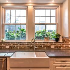 Contemporary Kitchen With Farmhouse Sink And Brick Backsplash