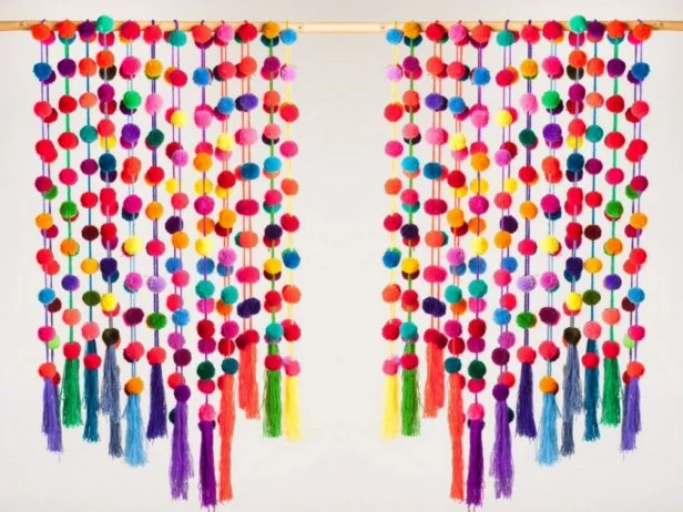 Garlands of Pom Poms Hanging Vertically From Pole