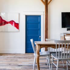 Wood Beams Draw Attention to Blue Dining Room Door