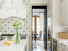 Traditional Kitchen With White Marble Countertops And Mosaic Tile Backsplash