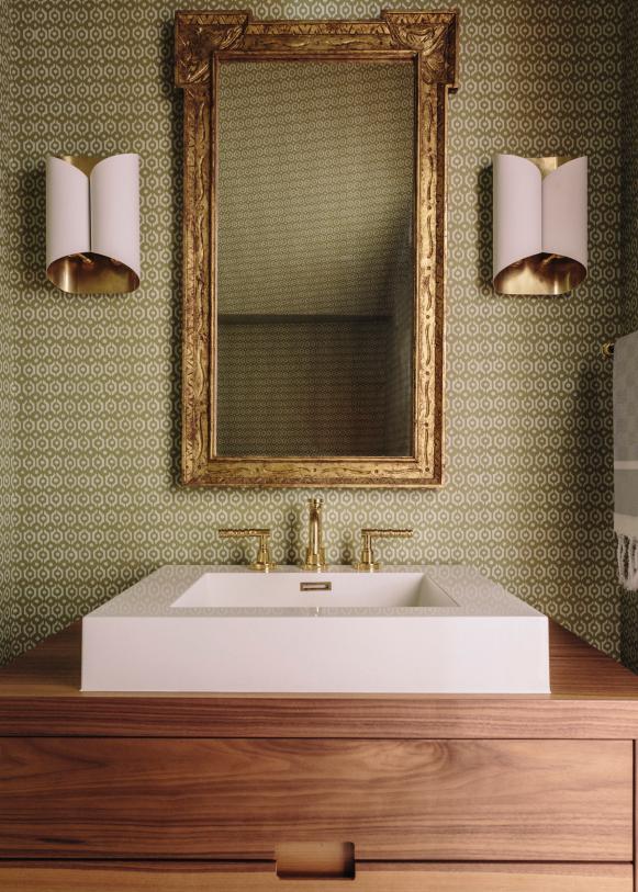 Powder Room With Modern Pink And Gold Accents And Sconces