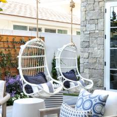 Blue and White Patio With Hanging Chairs