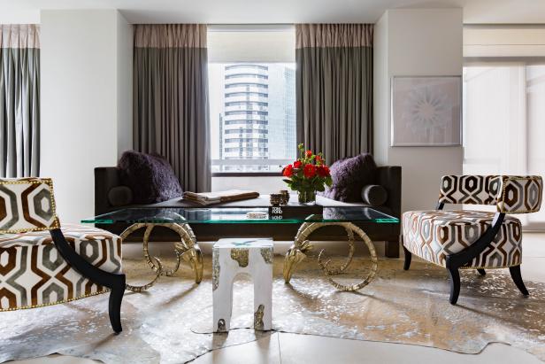 Modern Living Room With Purple Sofa And Graphic Print Side Chairs