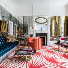 Eclectic Living Room With Blue Velvet Sofa And Retro Pink Side Chair And Rug With Vintage Accessories