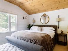 country-style master bedroom with wood ceiling