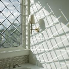 Classic White Guest Bathroom With Leaded Glass Window And Marble Sink Vanity