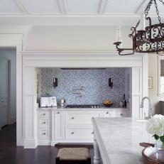 Classic White Country Kitchen With Blue Tile Mosaic Accents and Iron Chandelier