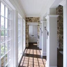 White Country Farmhouse Hallway With Wood And Stone Details