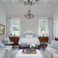 Classic White Country Master Bedroom With Neutral Accents And Iron Chandeliers