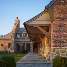 Brick And Stone Craftsmen Farmhouse With Flagstone Entrance Walk And Gas Pendants