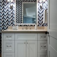 Bathroom Vanity With Beige Stone Top and Bold Wallpaper