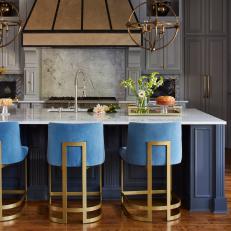 Classic Kitchen With Modern Upholstered Bar Stools And Pendants