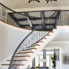 Modern Foyer With Contemporary Curved Staircase And Chandelier