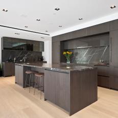 Modern Kitchen With Dark Brown Cabinets and Stone Backsplash