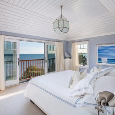 Gray Coastal Master Bedroom With Balcony View