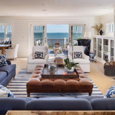 Blue and White Coastal Living Room With Leather Ottoman
