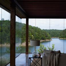 Modern Cabin Living Room With Window Walls And Lake Views