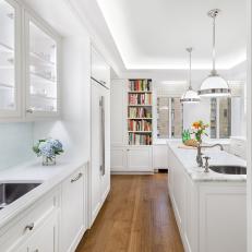 Traditional White Kitchen With Recessed Lighting And Marble Counter Accents