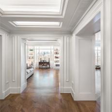 Traditional White Hallway With Custom Woodwork And Illuminated Tray Ceiling