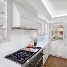 Traditional All White Kitchen With Glass Front Cabinets And White Vent Hood